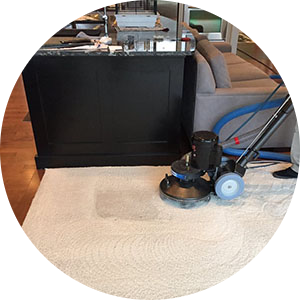 Colorful area rug being cleaned with specialized equipment.